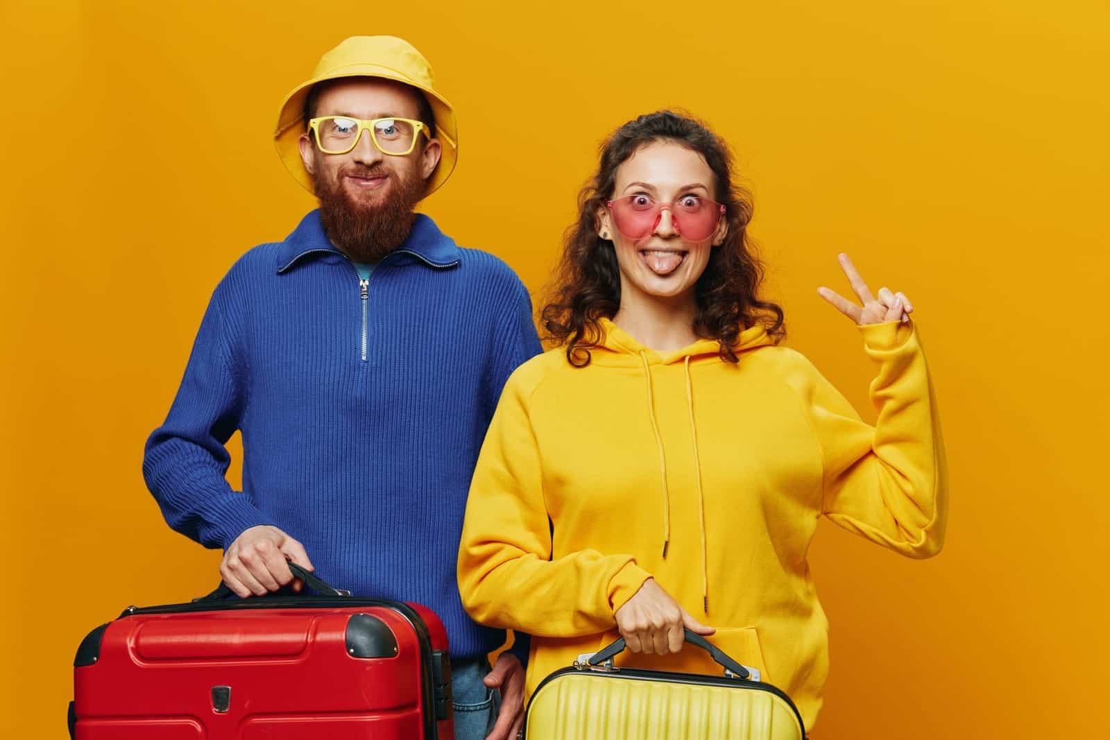 man and woman with suitcases ready for travelling