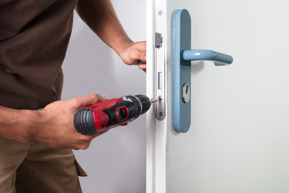 Locksmith drilling on door lock