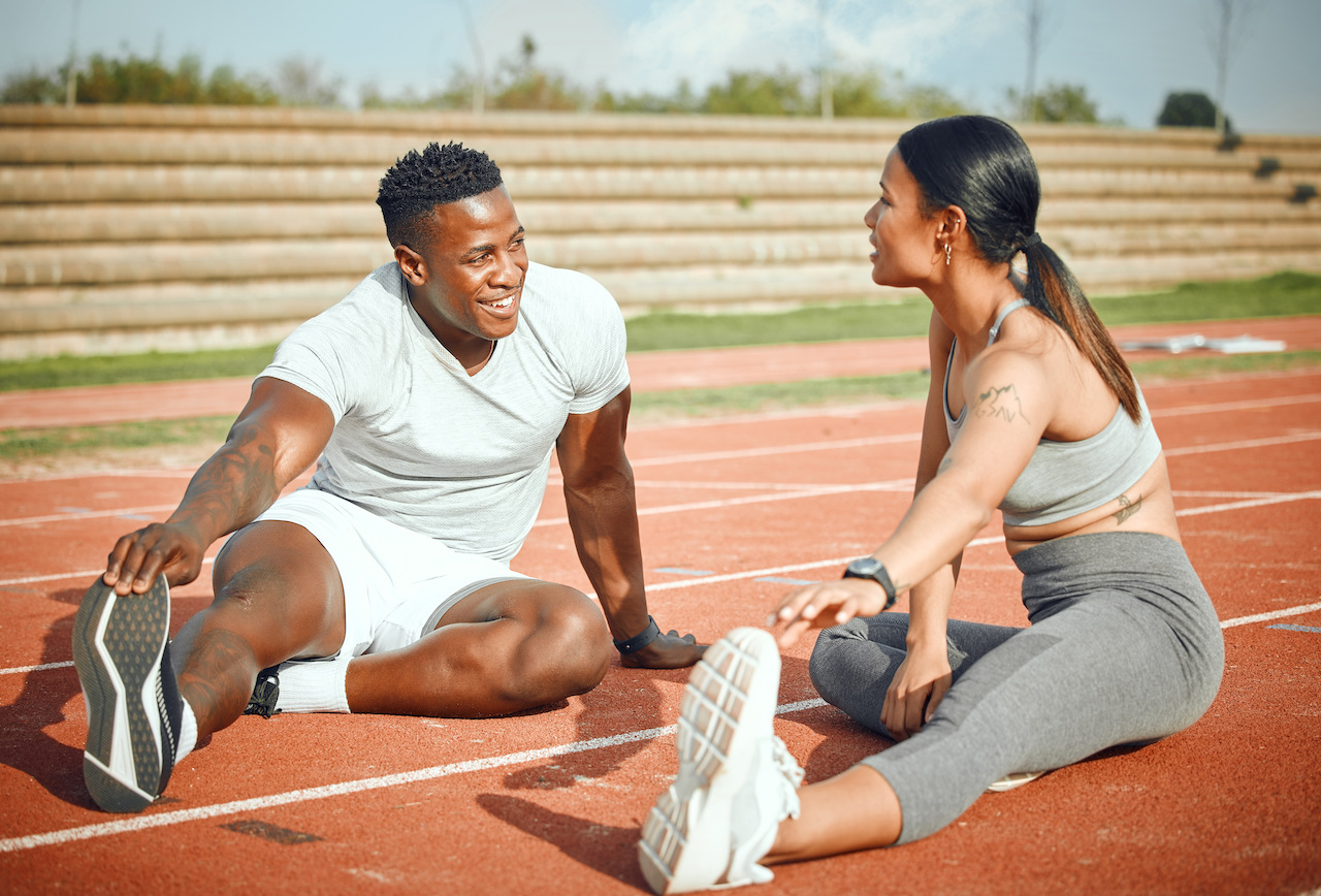 Two people stretching before run