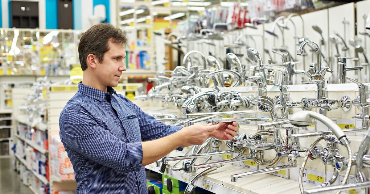 man choosing taps for bathroom fixtures