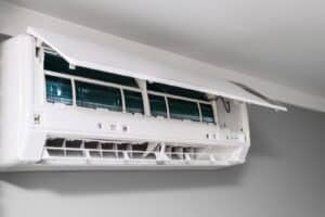 Home air conditioner with open lid for repair and cleaning